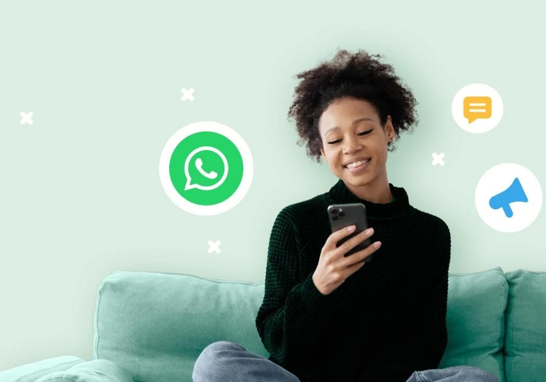 Smiling woman using phone with digital communication icons.