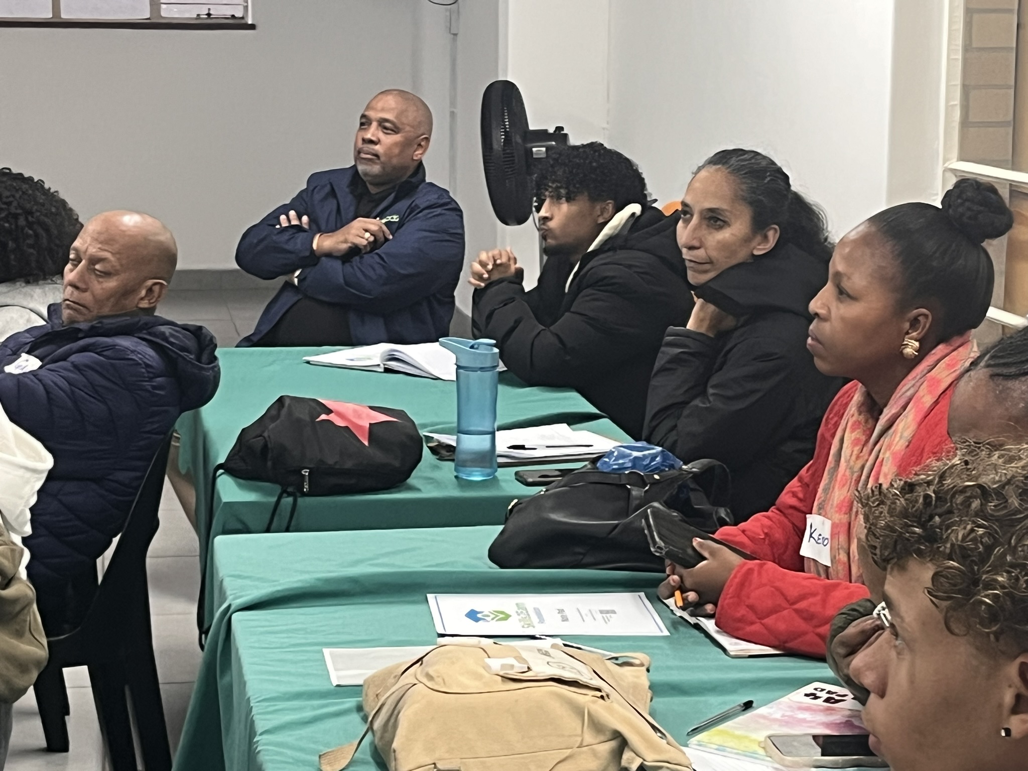 Adults attending community meeting indoors
