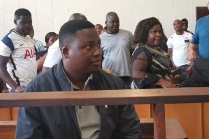 People gathered in a courtroom setting.