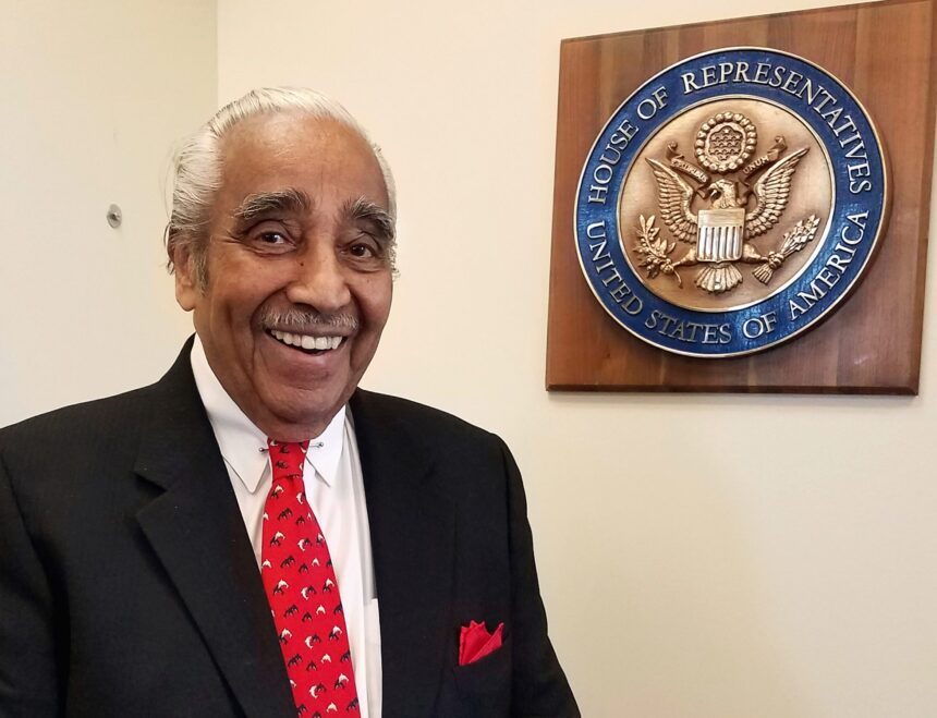 Man smiling near U.S. House of Representatives plaque.