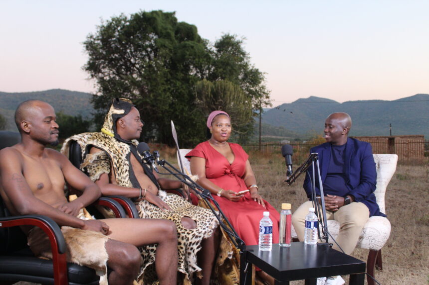 Outdoor podcast interview with four people and microphones.