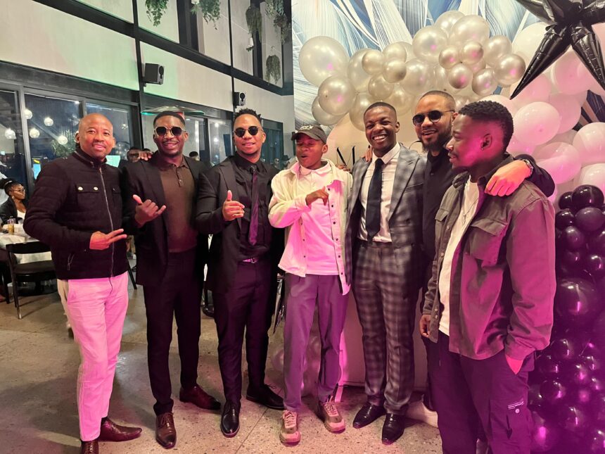 Group of men celebrating at a festive event.