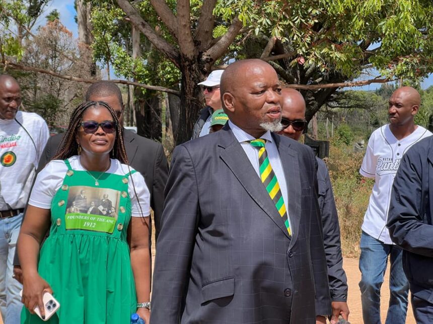 Group walking outdoors, man in striped tie leading.
