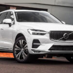 White SUV parked in front of building