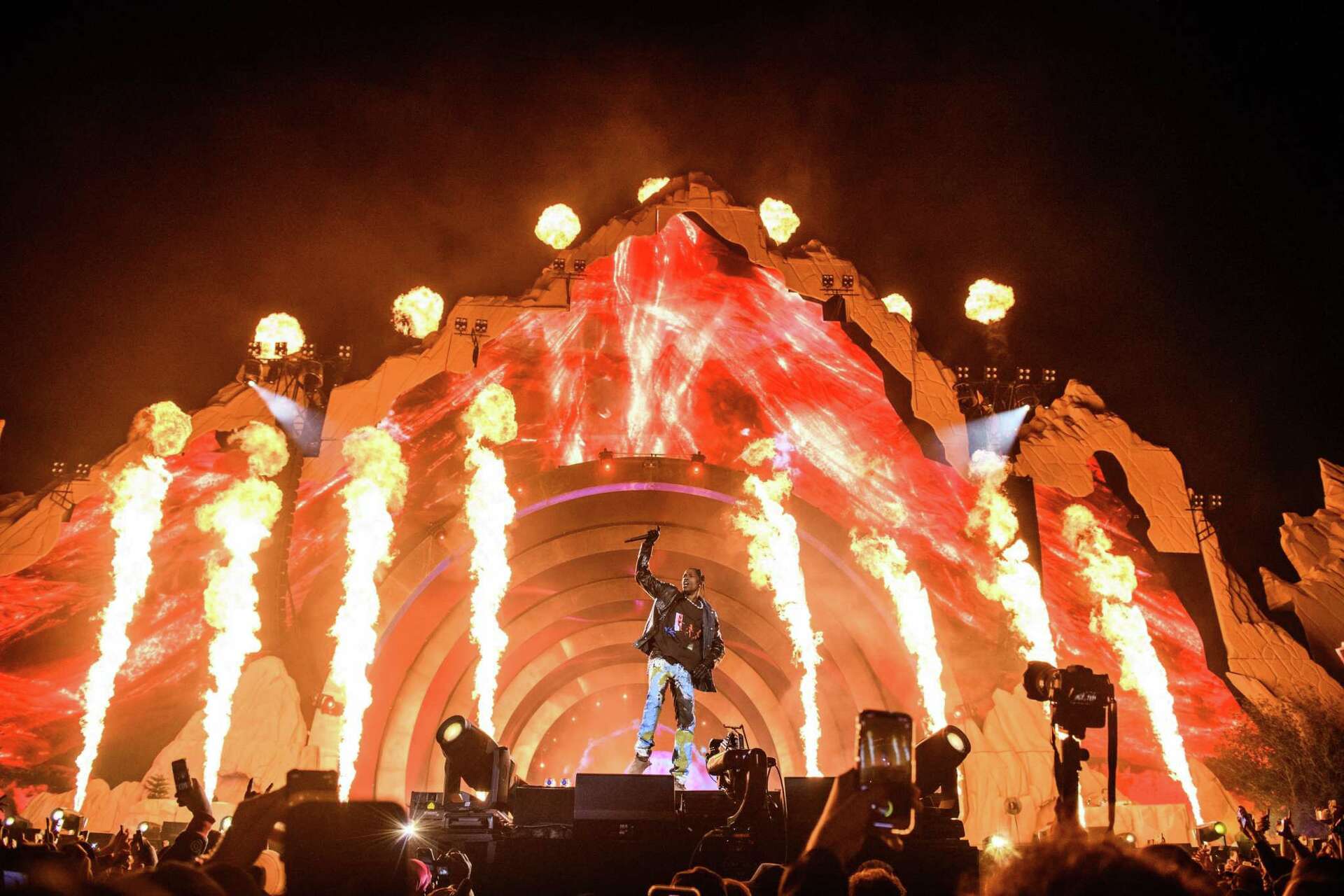 Performer on stage with fiery visual effects.