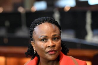 Woman attending a formal indoor event, focused expression.