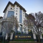 Nedbank building exterior with trees.