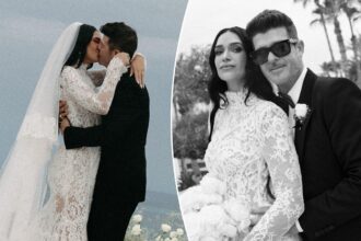 Wedding couple embracing and posing outdoors.