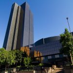 Modern office building with reflective glass facade.