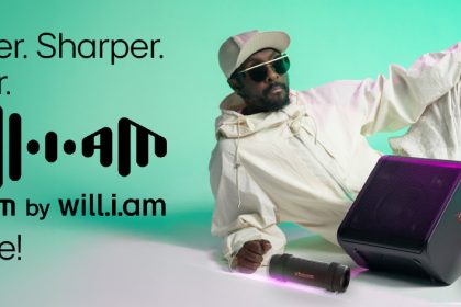 Person with speakers, Xboom by will.i.am advertisement.