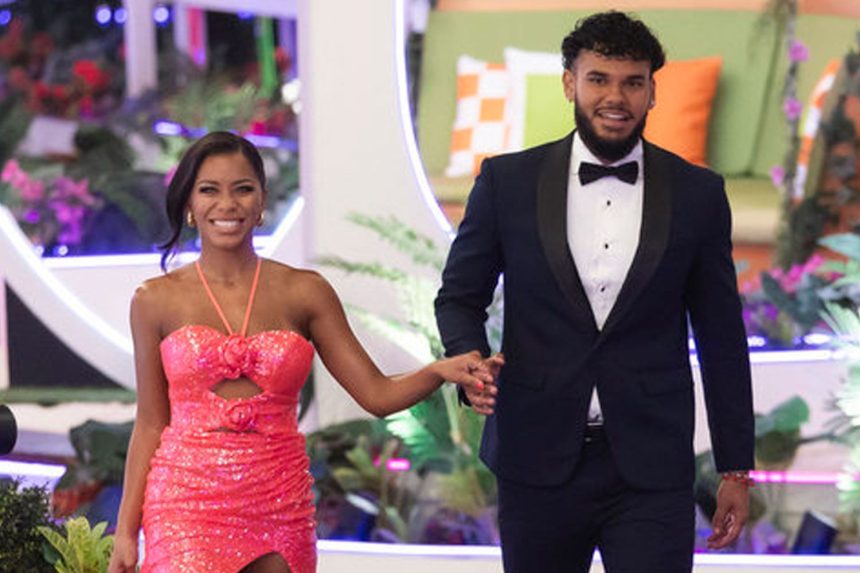 Couple in formal attire on colourful set.