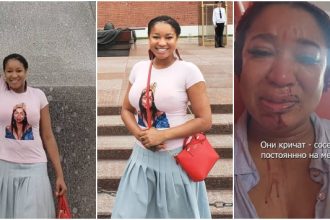 Woman posing confidently and holding passport.