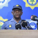 Police officer speaks at press conference.