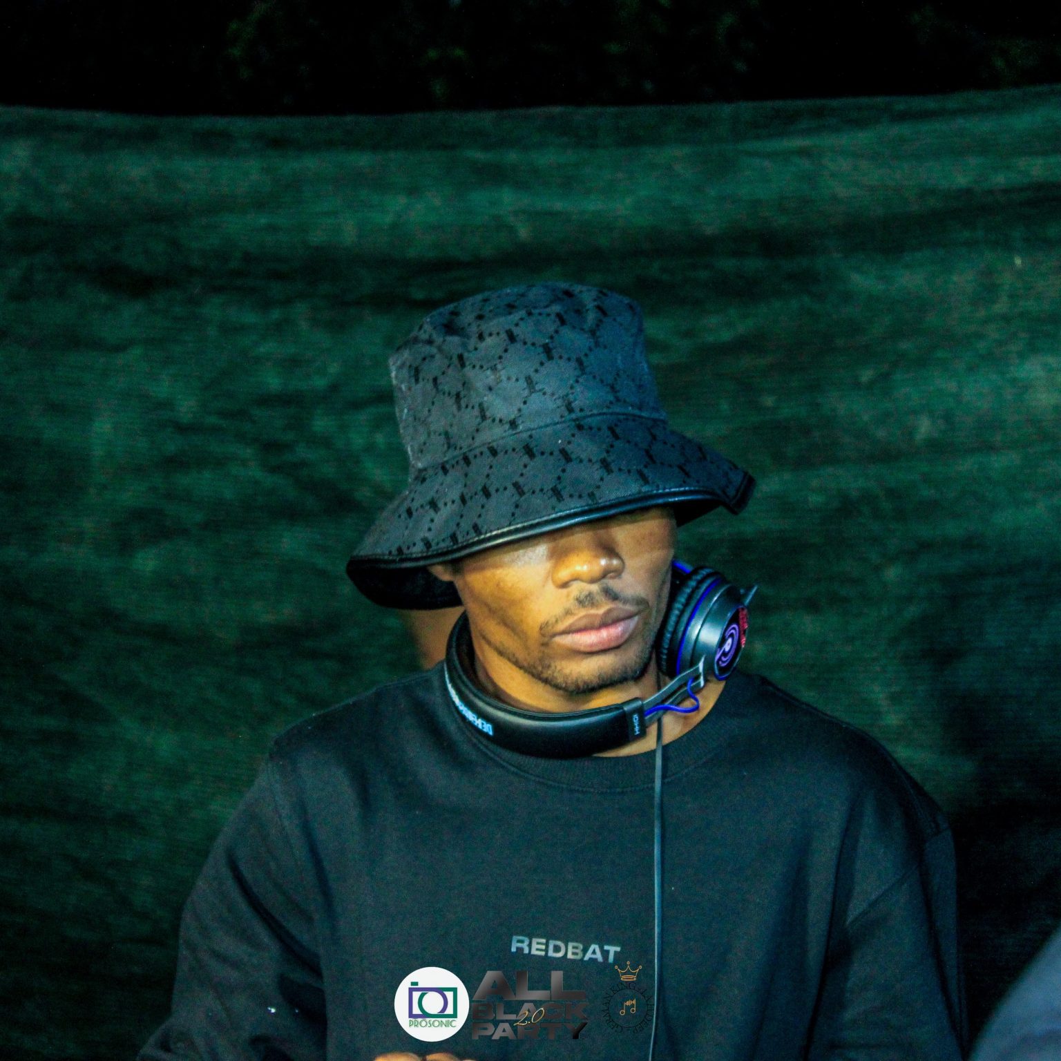 DJ performing at outdoor event with headphones