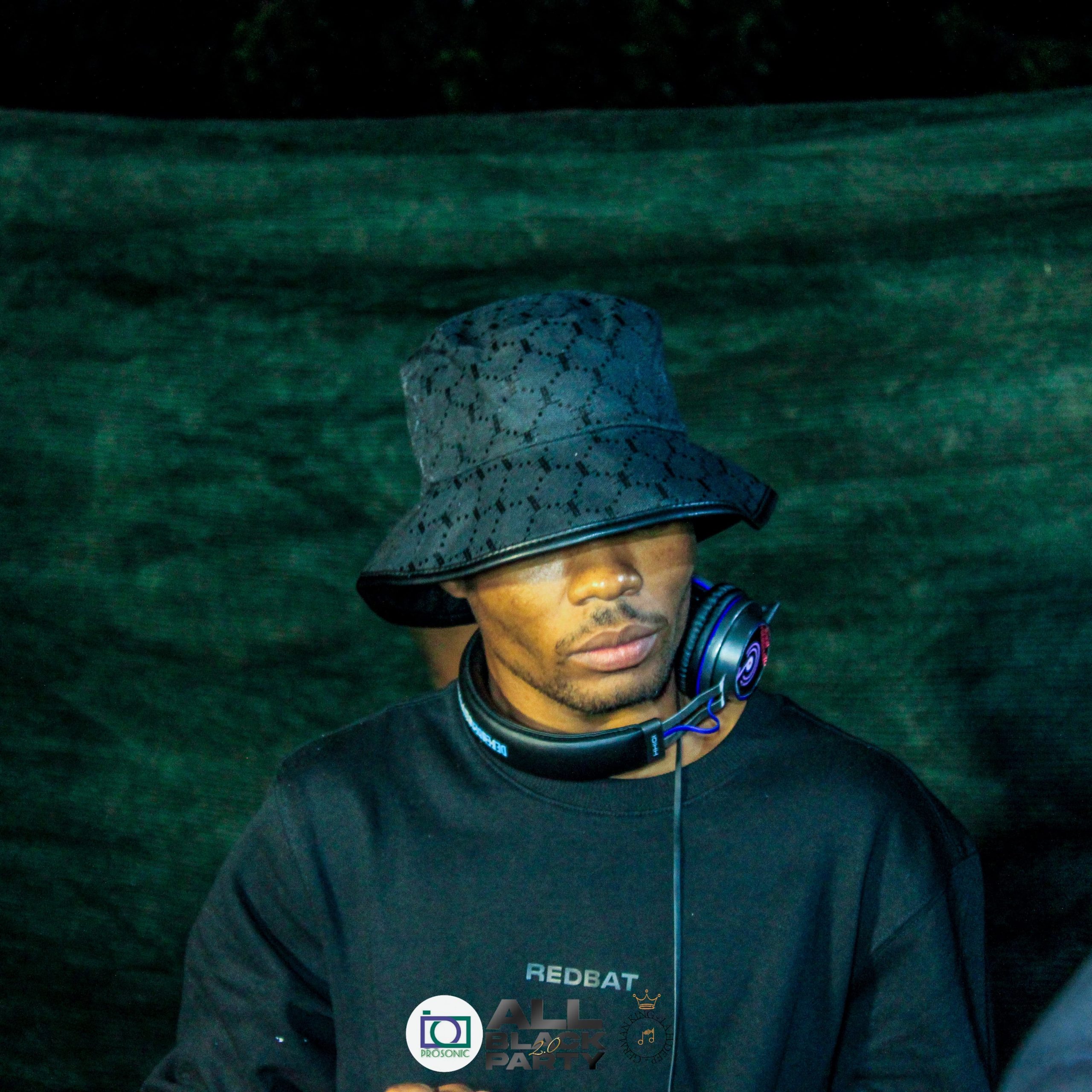 DJ performing at outdoor event with headphones