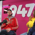 Radio hosts in lively studio conversation.