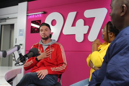 Radio hosts in lively studio conversation.