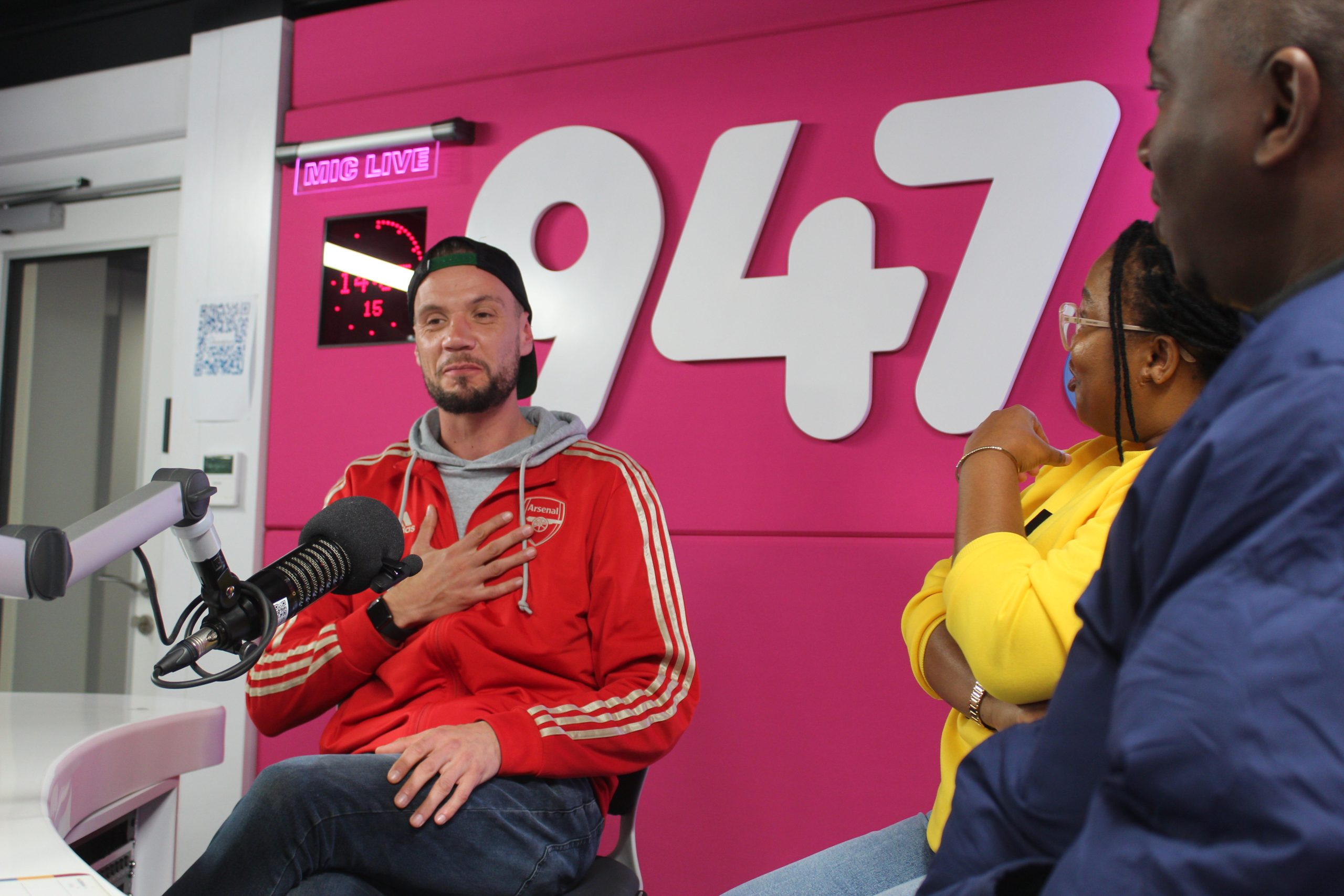 Radio hosts in lively studio conversation.