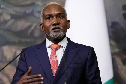 Man in a suit giving a speech.