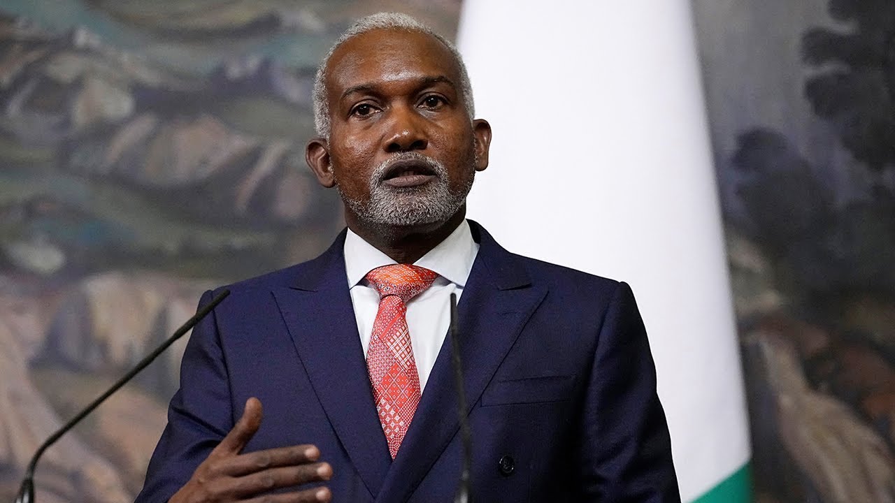 Man in a suit giving a speech.