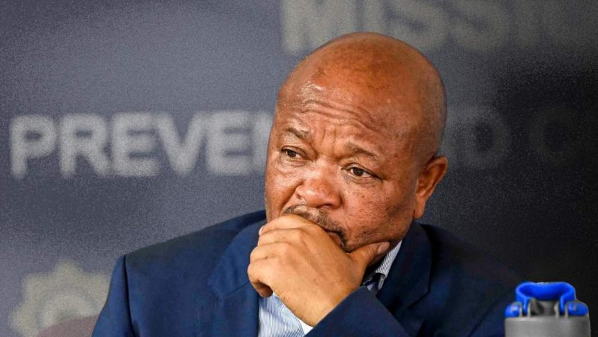 Thoughtful man seated at a press conference.