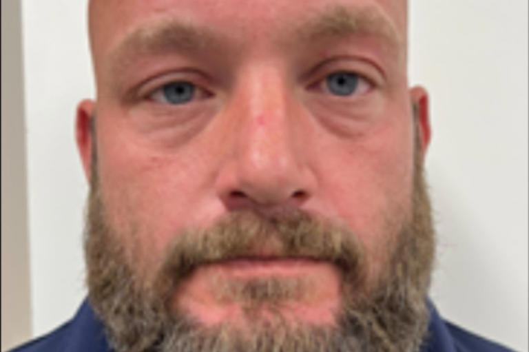 Man with beard looking directly at camera.