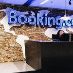 Booking.com reception area with employees working.
