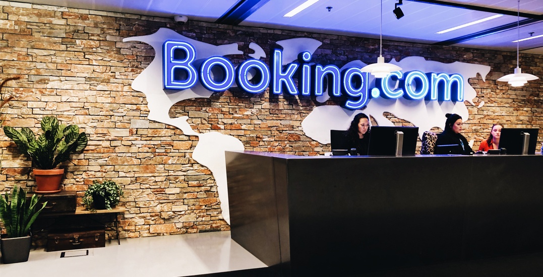 Booking.com reception area with employees working.