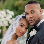 Elegant couple in wedding attire, outdoor setting.