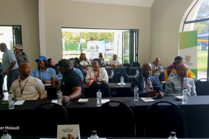 Conference attendees sitting at tables in a room.