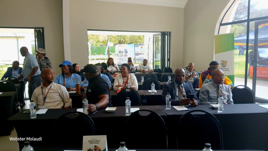 Conference attendees sitting at tables in a room.