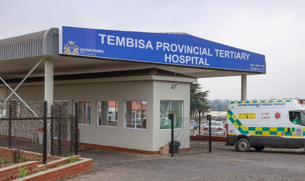 Tembisa Provincial Tertiary Hospital entrance with ambulance.