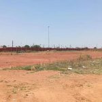 Open dusty field under clear sky, South Africa
