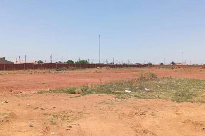 Open dusty field under clear sky, South Africa
