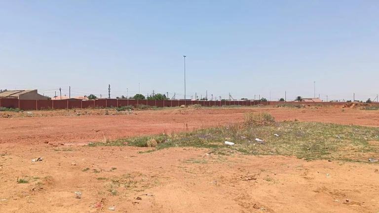 Open dusty field under clear sky, South Africa