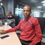 Man in radio station studio with microphone