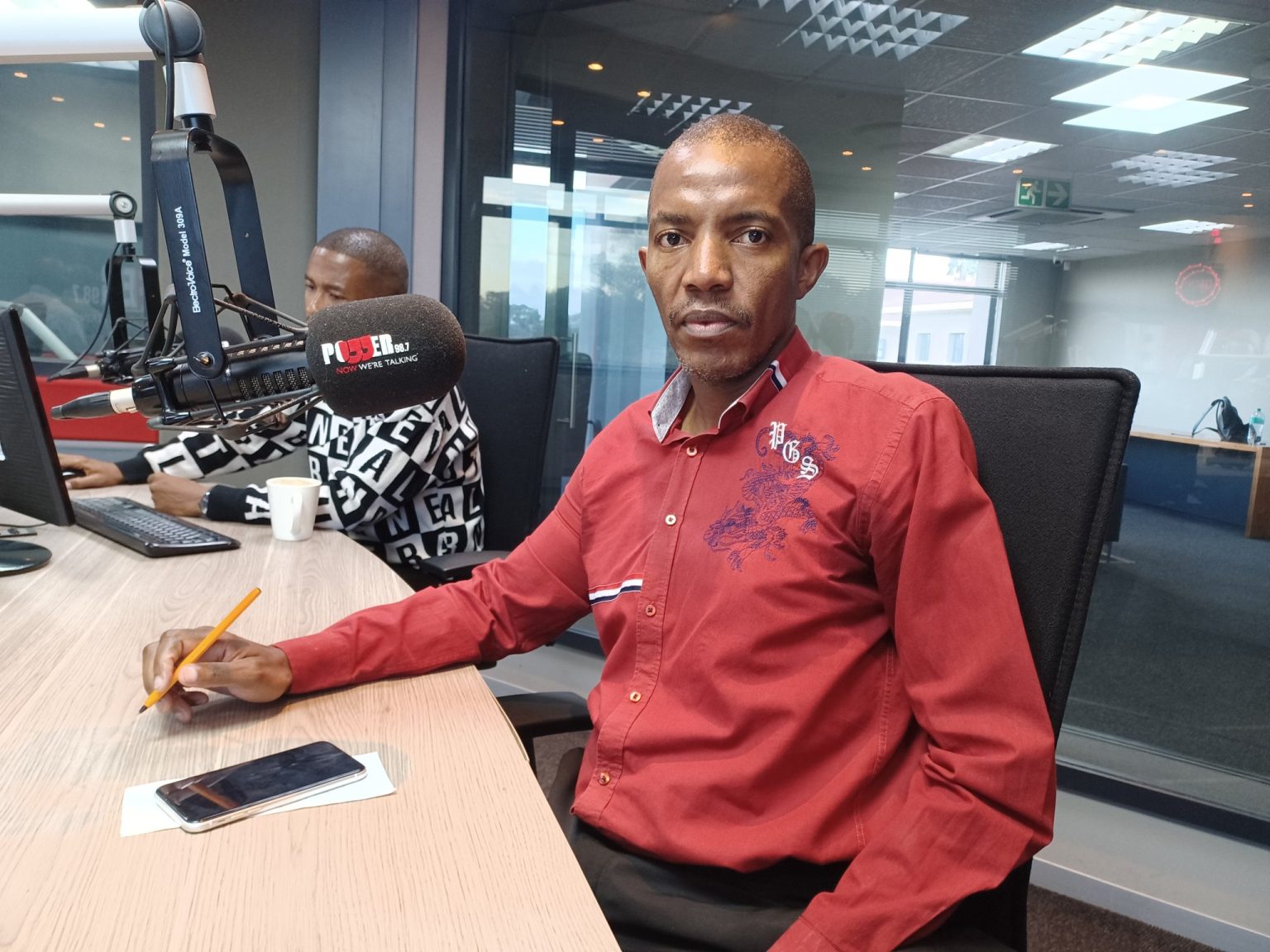 Man in radio station studio with microphone