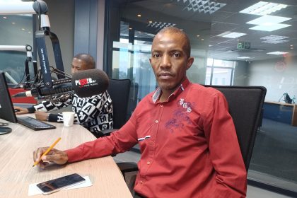 Man in radio station studio with microphone