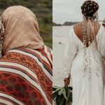Couple in traditional attire on a beach.