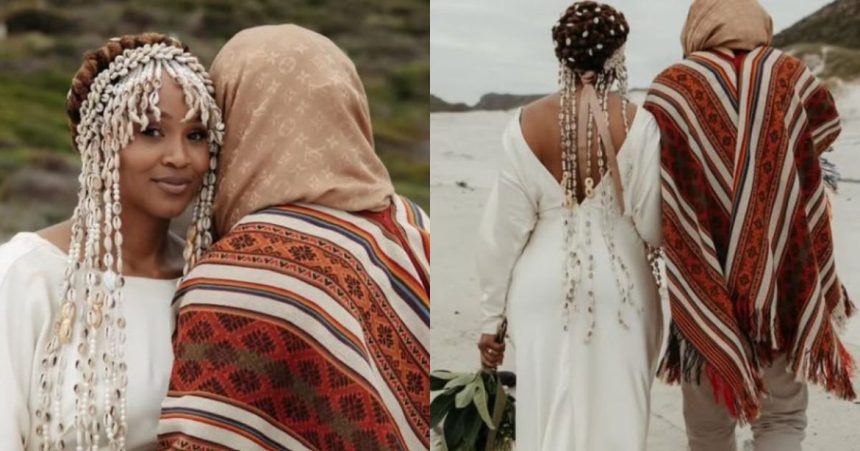 Couple in traditional attire on a beach.