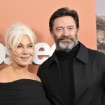 Two people smiling at an event.