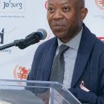 Man speaking at a Johannesburg event.