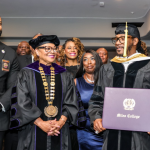 Miles College graduate receiving diploma at ceremony.