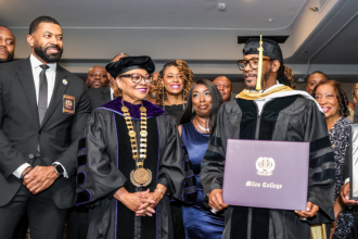 Miles College graduate receiving diploma at ceremony.