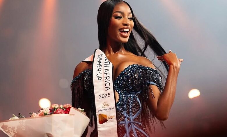 Pageant runner-up smiles with flowers on stage.