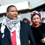Man and woman attending an outdoor event.