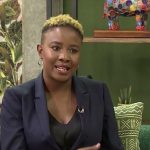 Person speaking on a vibrant, colourful set.