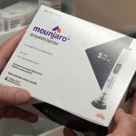 Mounjaro packaging for prescription injections held by hands.