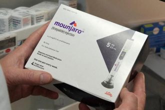 Mounjaro packaging for prescription injections held by hands.
