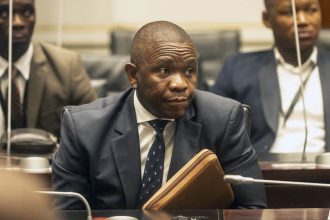 Man in suit at meeting with folder